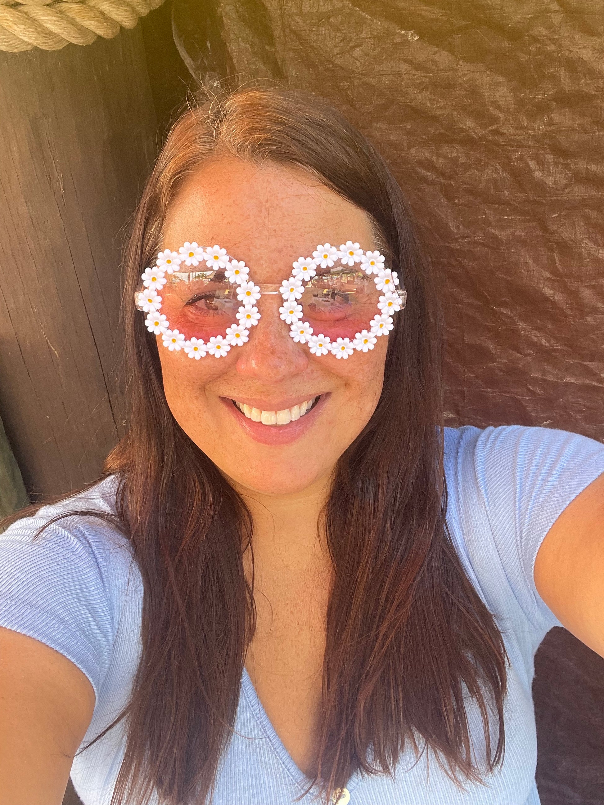 woman wearing daisy sunglasses